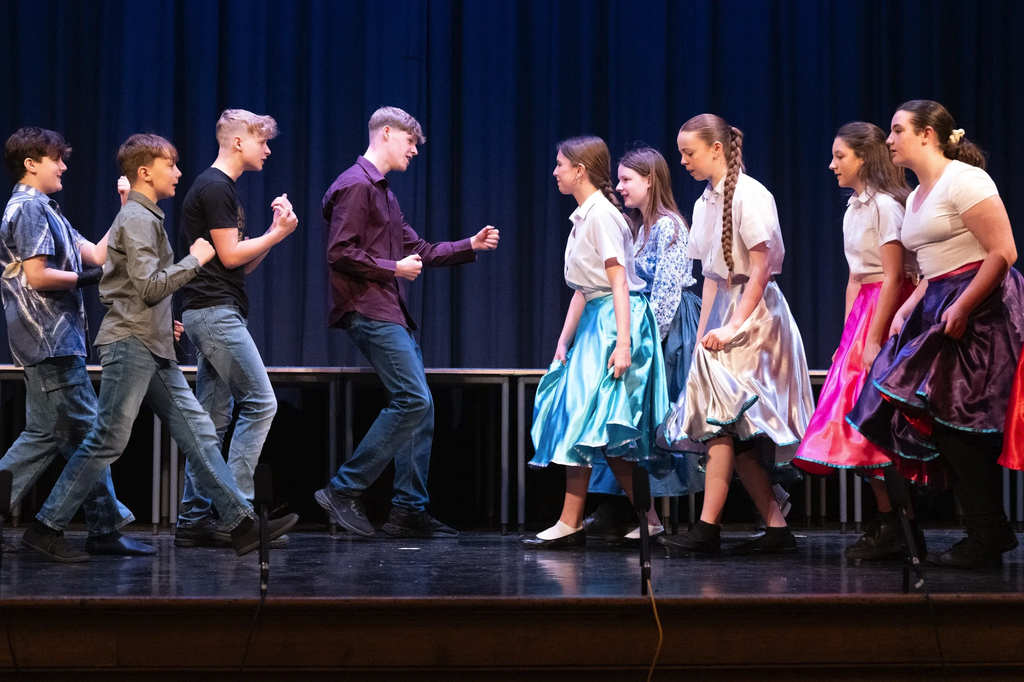 Cast performing a lively group number