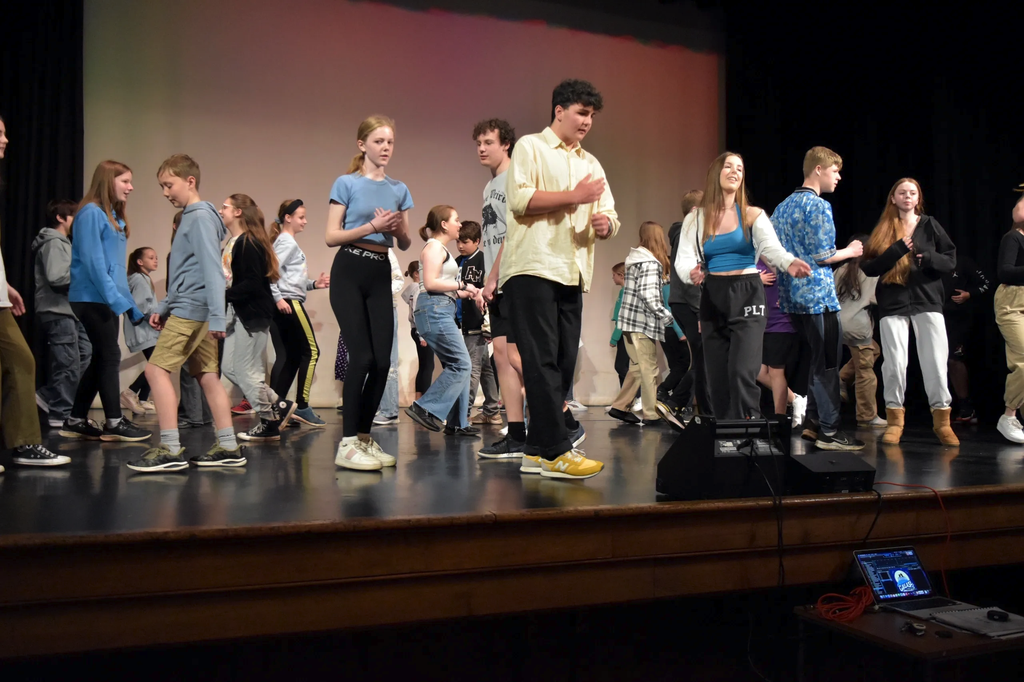 Cast dancing a hand-jive number