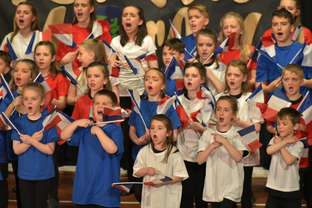 Ensemble singing together on stage